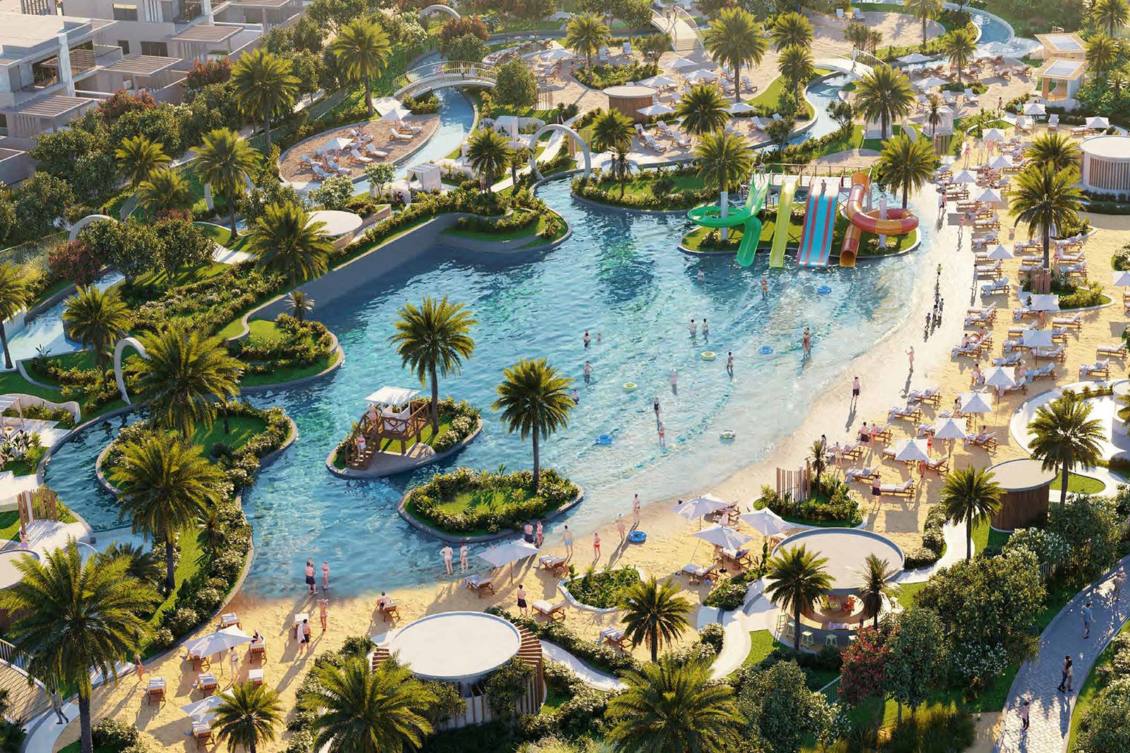 Aerial view of a resort-style lagoon with sandy beaches, palm trees and water play areas