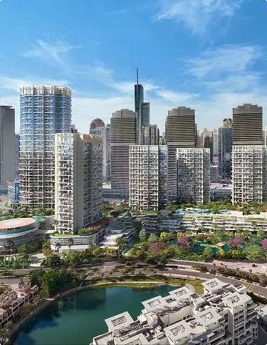 Aerial view of high-rise towers beside a lake and low-rise residences