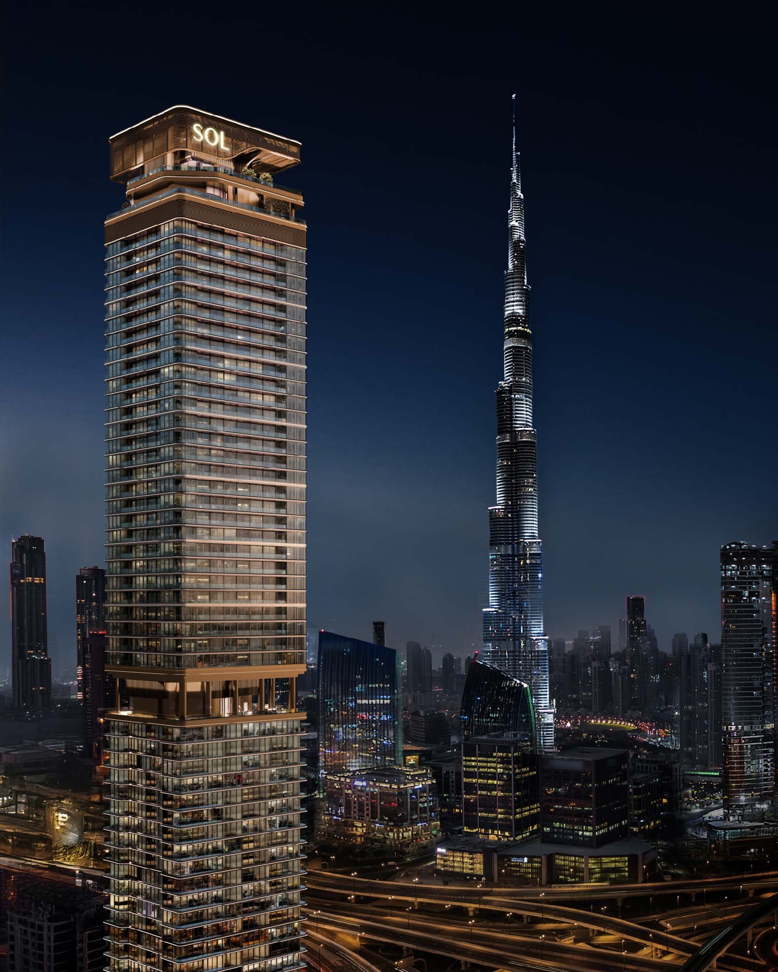 Tall residential tower beside Burj Khalifa at night