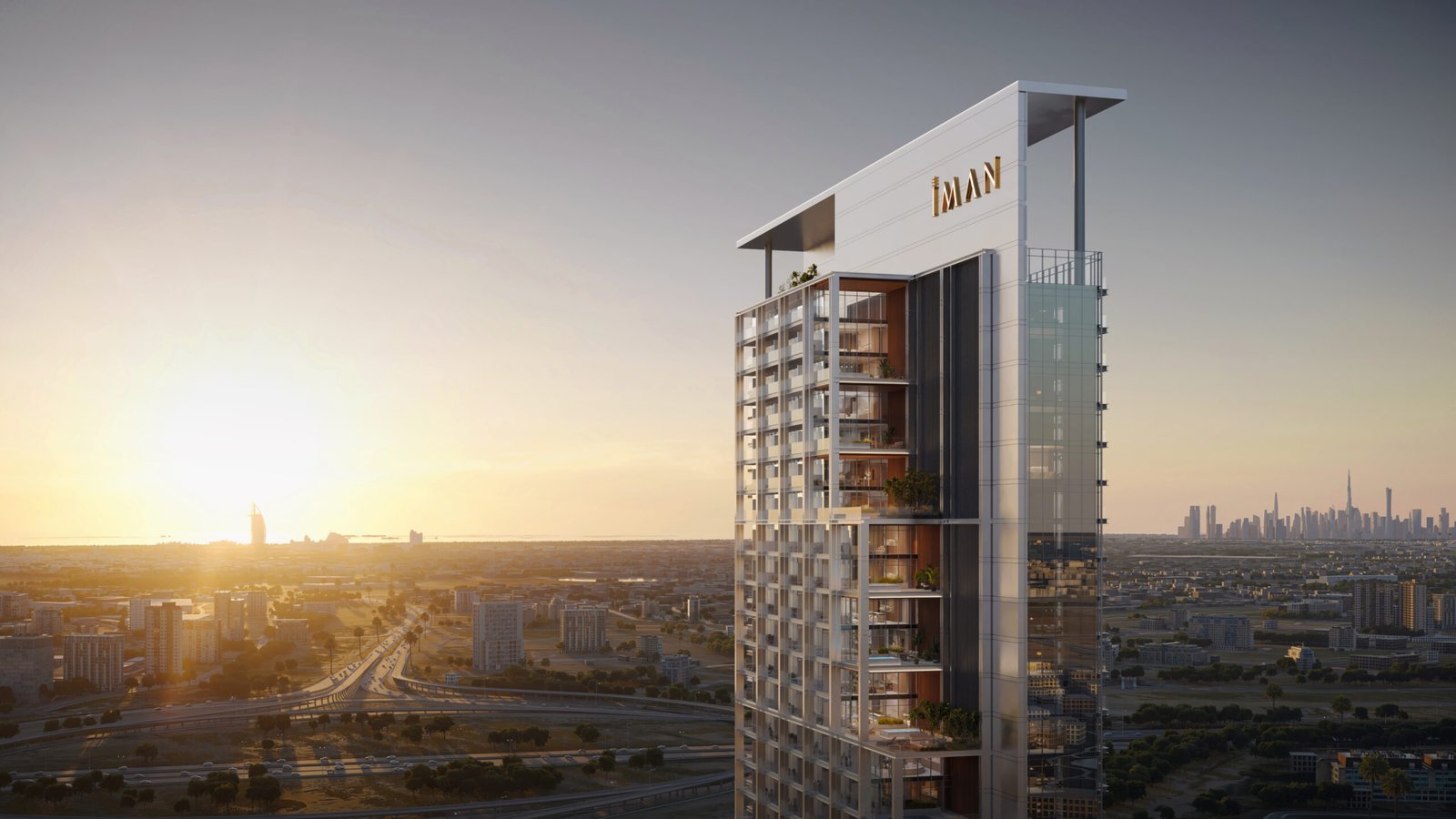 IMAN residential tower at sunset above a flat city skyline