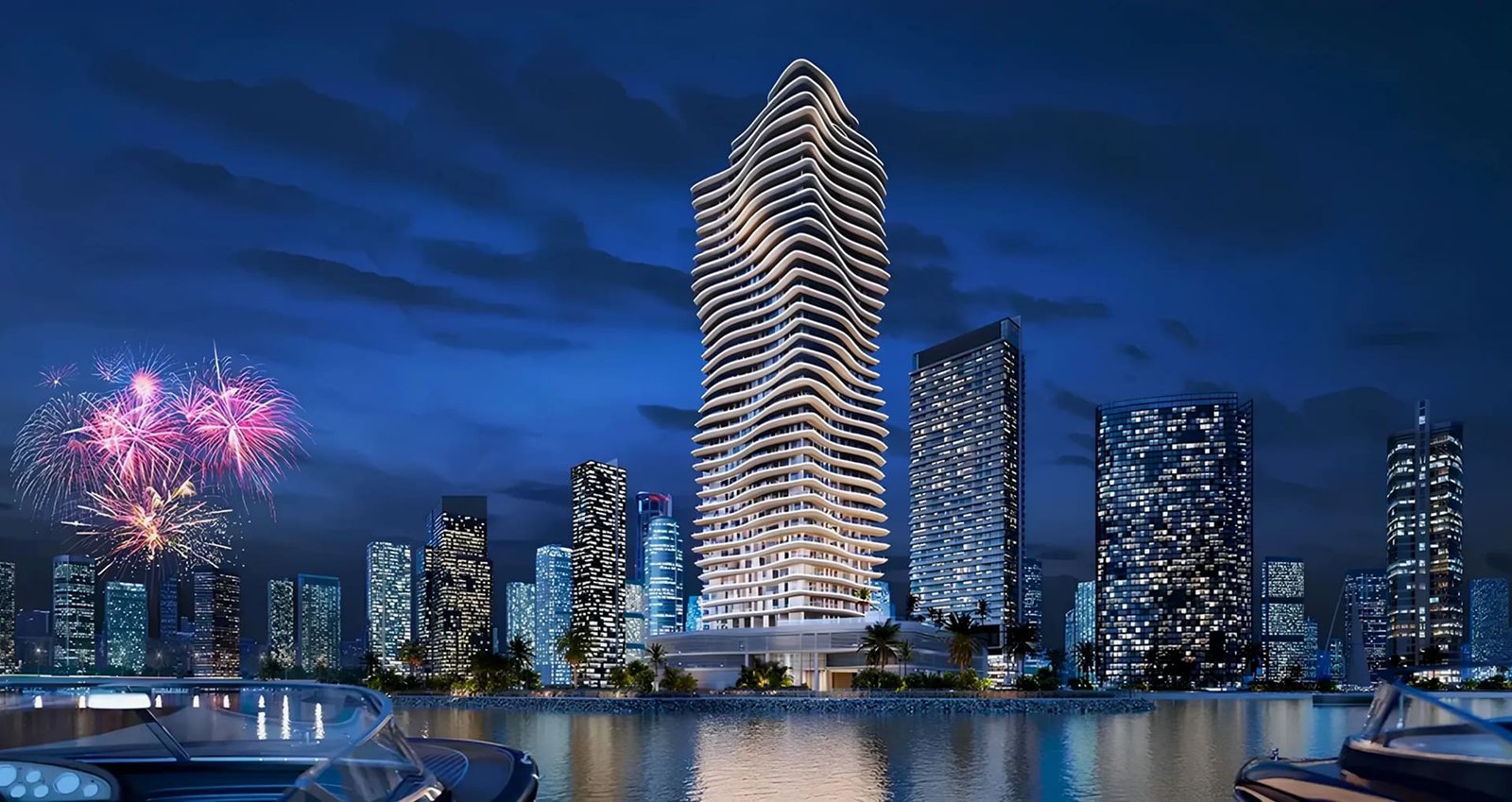 Illuminated waterfront skyline at night with a curved tower and fireworks