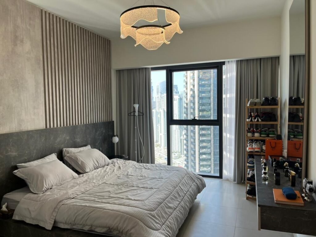 BLVD Central — 1 Bed — bedroom with chandelier and city view