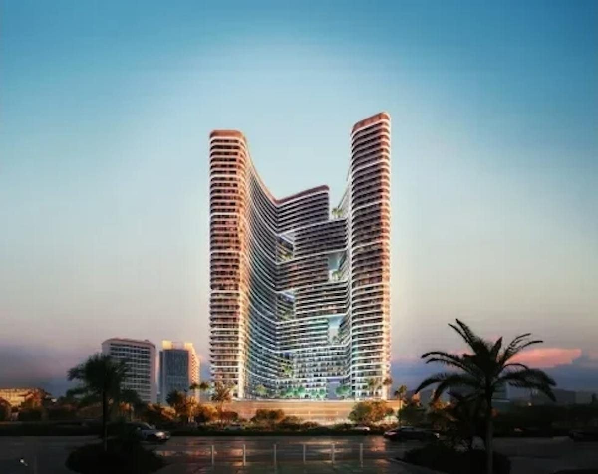 Wave-shaped residential tower with banded balconies at dusk beside palm trees, rendered view