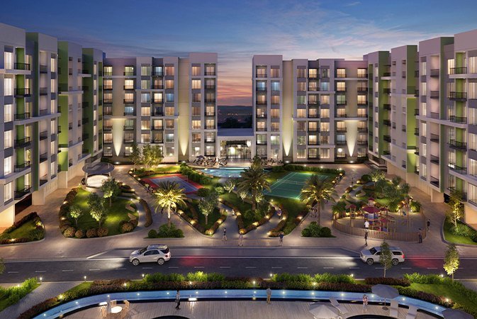 Mid-rise apartment buildings around a landscaped courtyard with pool at dusk, rendered view